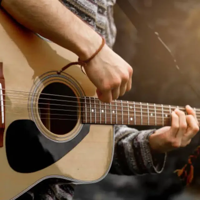 Close-up of hands playing an acoustic guitar