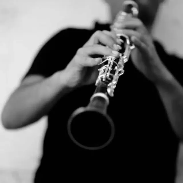 Black-and-white close-up of a clarinet being played