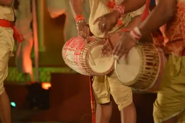 Dhol players in traditional dress drumming