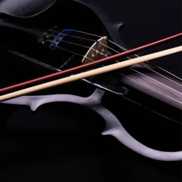 Close-up of an electric violin and bow on a dark background