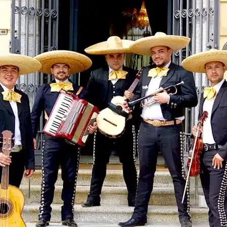 Mariachi band in sombreros with guitars, violin and accordion