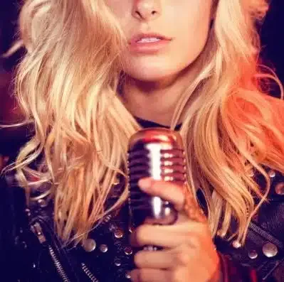 Blonde singer holding a vintage microphone
